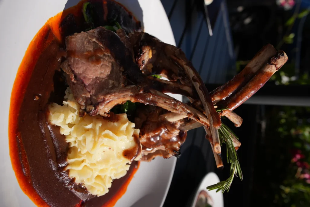 Rack of lamb plated with whipped potatoes and rosemary