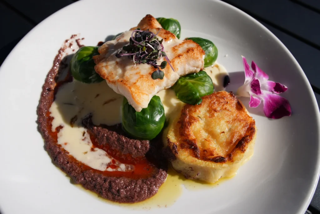 Pan-seared fish with Brussels sprouts and golden potato at Mezza Luna Bistro